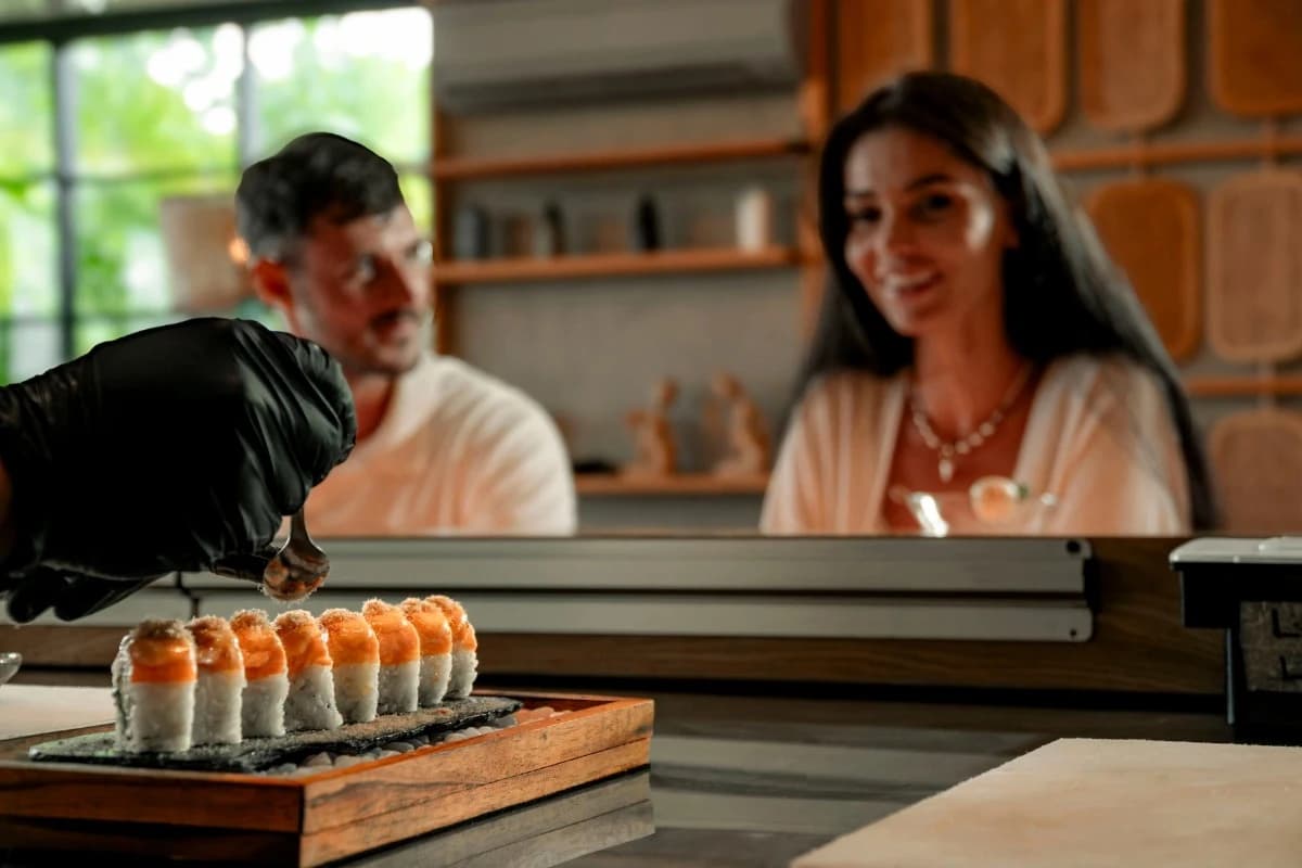 Sushi chef preparing sushi while guests enjoy dining at a restaurant in Ubud.