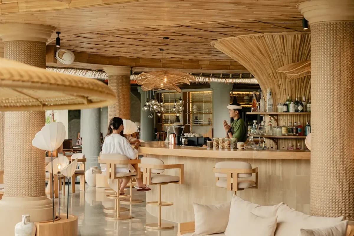 Modern cocktail bar in Bali with bamboo design, bar seating, and a relaxed atmosphere.