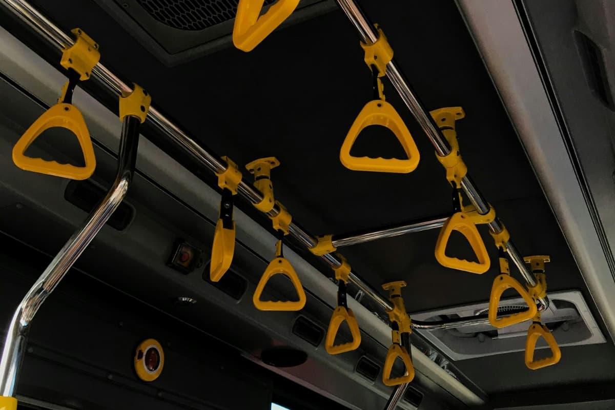 Hand straps inside a public bus used by travelers and local commuters in Bali.