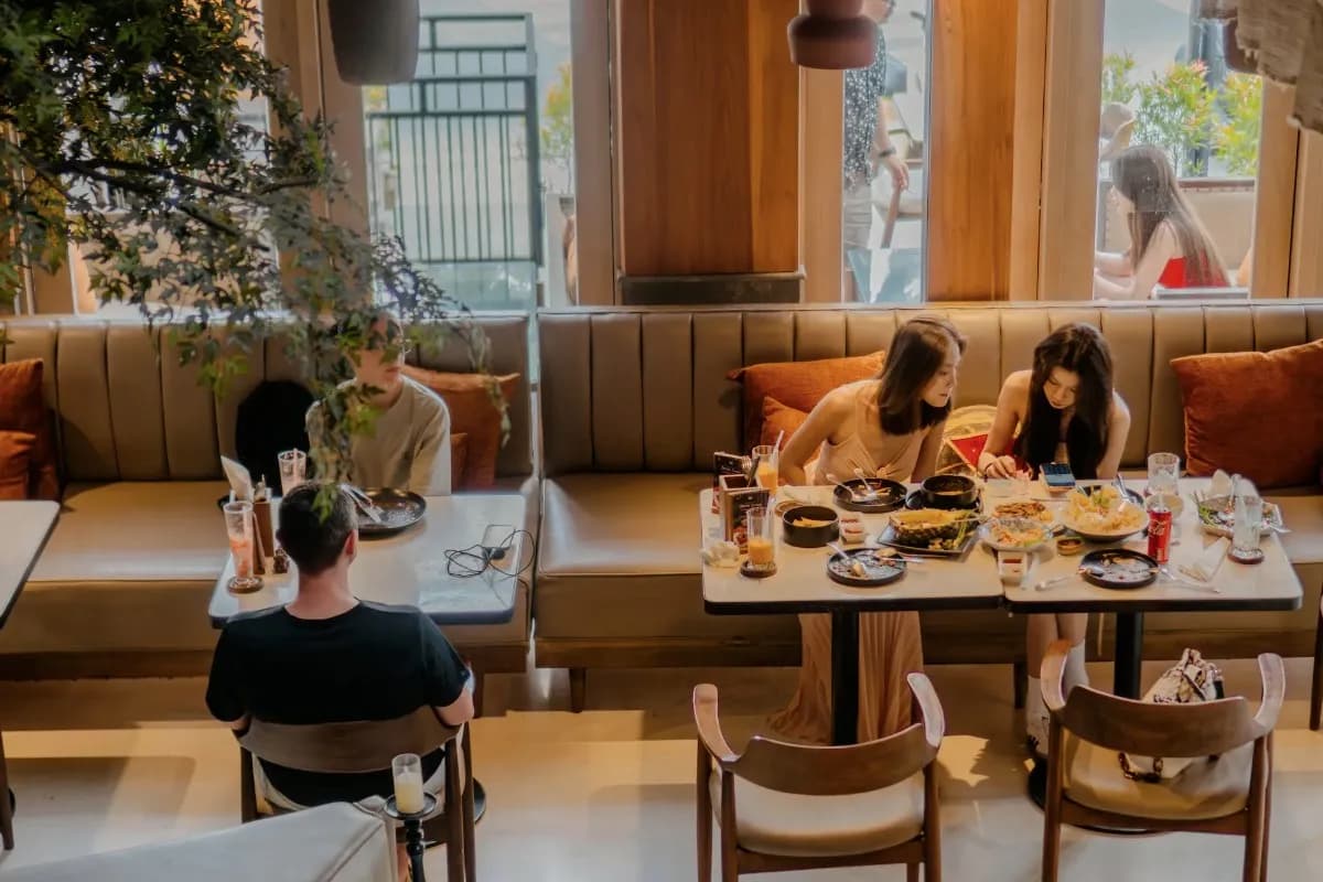 People enjoying lunch together in a busy Canggu restaurant, showing a popular place for a midday meal.