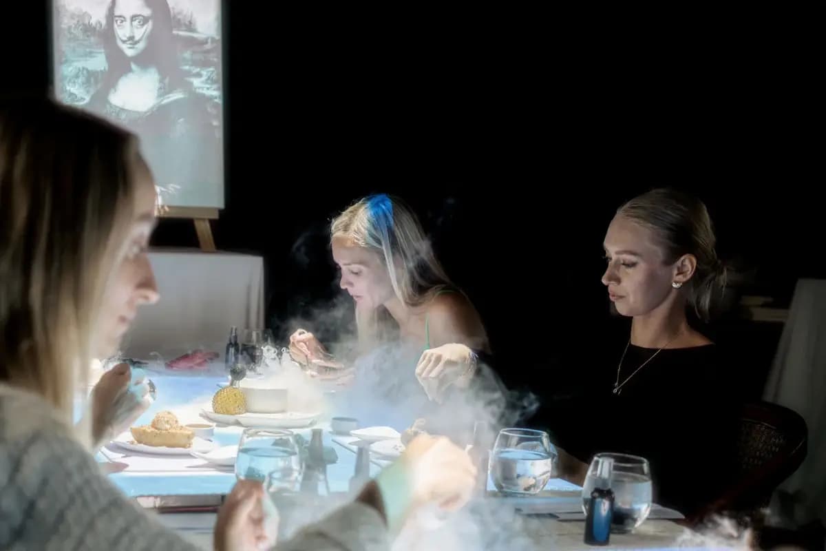Guests enjoy an interactive dining experience in Ubud with visual effects and creative food presentation at the table.