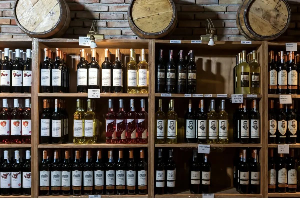 Shelves display a wide selection of wine bottles in a Bali wine shop, organized by type and label.