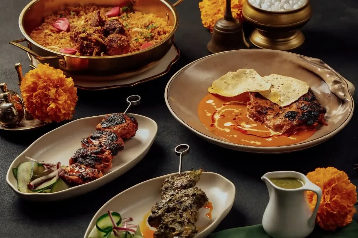 A selection of Indian dishes in Ubud, including spiced rice, grilled meats, curry, flatbread, and sauces.
