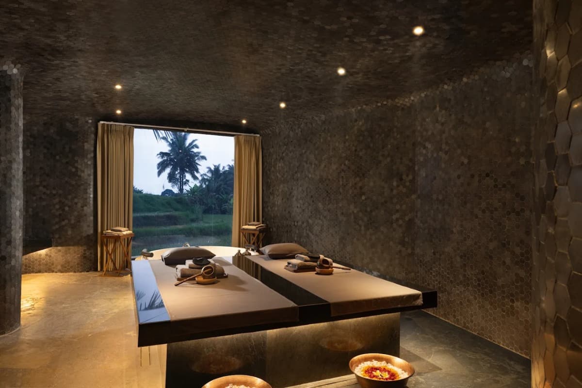 Calm spa room with massage beds, soft lighting, and garden view, showing a hammam spa experience in Bali.