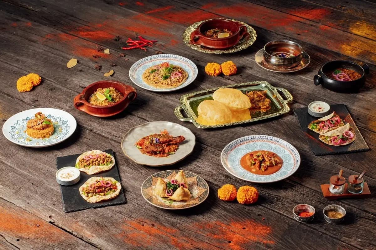 Berbagai hidangan India tersaji di meja, menunjukkan pilihan menu restoran India di Bali yang wajib dicoba wisatawan.