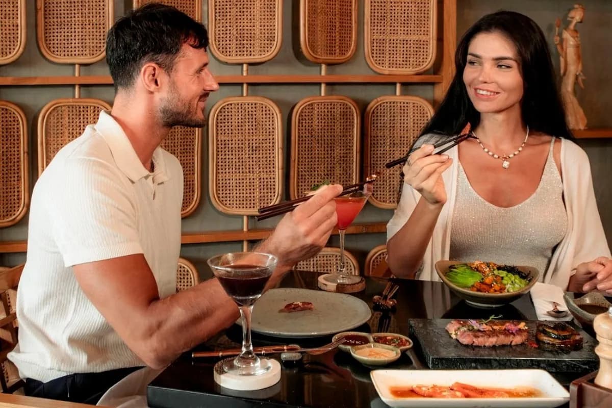 Couple enjoying Japanese food and drinks in Ubud, showing a casual restaurant dining experience.